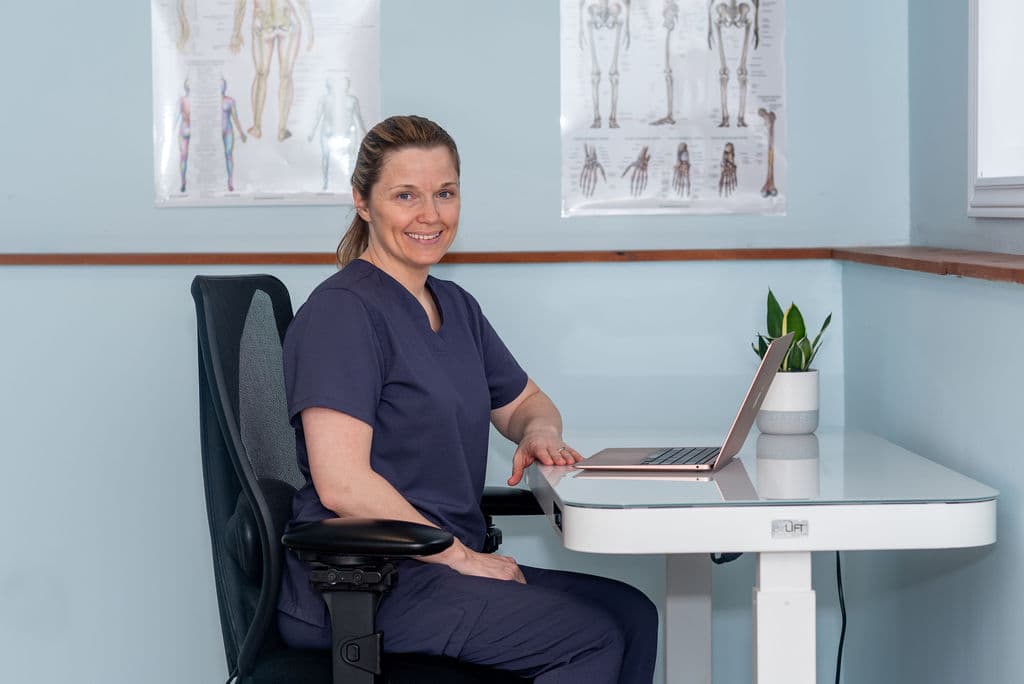 Osteopath sitting at a desk